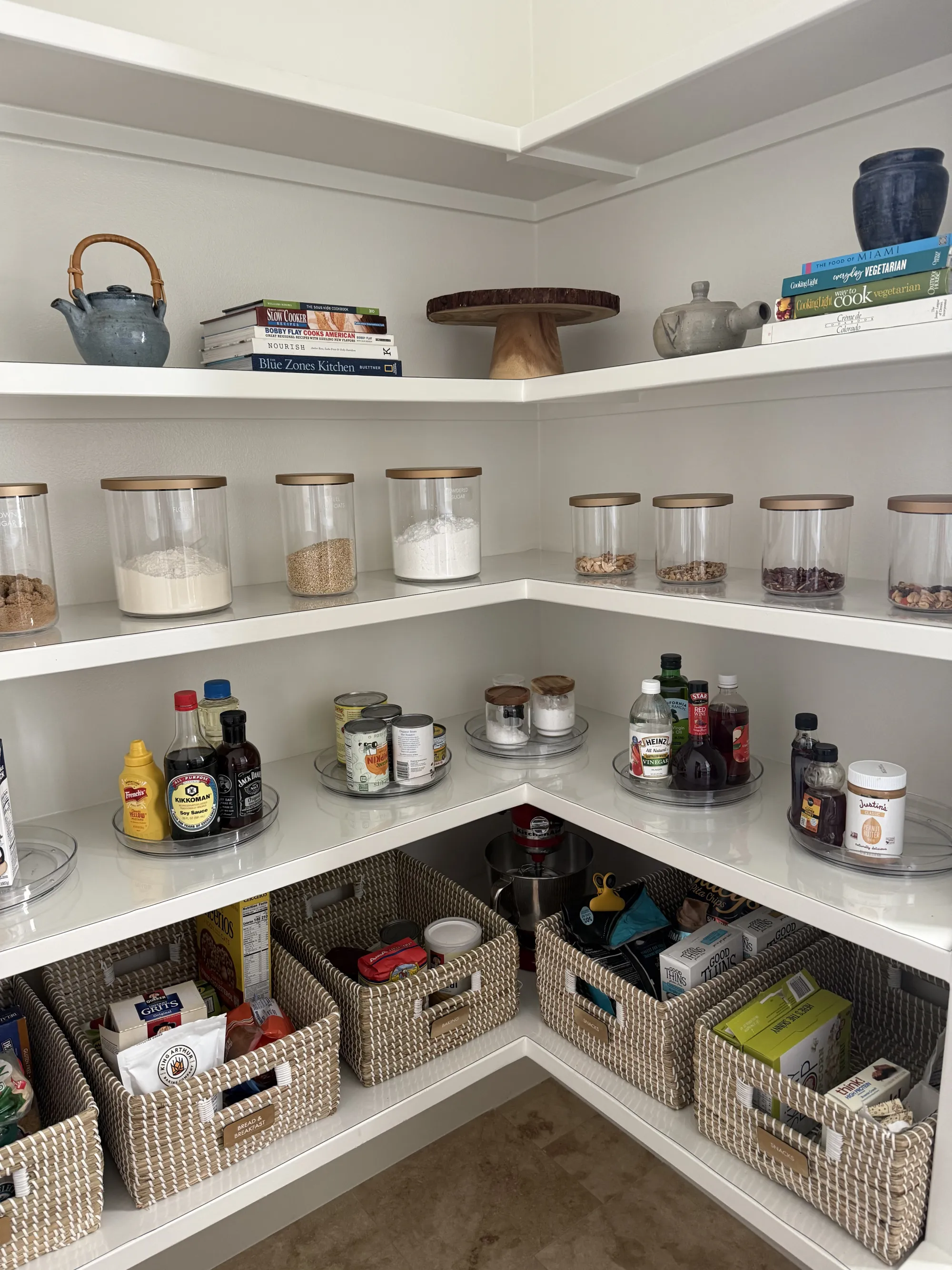 Organized walk-in pantry with lined corner shelves